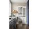 Modern kitchen featuring navy cabinets, gold hardware, and a white farmhouse sink at 23 Clifton Ne St, Atlanta, GA 30317