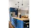 Stylish kitchen island featuring a wood countertop, ample storage, and modern lighting fixtures at 23 Clifton Ne St, Atlanta, GA 30317