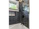 Shower with black subway tile with white grout and updated shower fixtures with matching bathtub at 23 Clifton Ne St, Atlanta, GA 30317