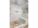 Modern shower with glass doors, river rock floor, marble tile, rainfall shower head, and built-in bench at 23 Clifton Ne St, Atlanta, GA 30317