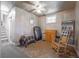 Open basement area featuring neutral flooring, a window, and a comfortable rocking chair at 2592 Dresden Dr, Atlanta, GA 30341