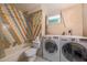 Full bathroom with combination tub and shower, toilet and washer and dryer at 2592 Dresden Dr, Atlanta, GA 30341