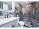 Stylish bathroom featuring tiled shower with glass door, marble vanity, and modern fixtures at 2592 Dresden Dr, Atlanta, GA 30341