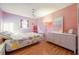 Bright bedroom with hardwood floors, large window, and light pink walls at 2592 Dresden Dr, Atlanta, GA 30341