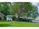 Inviting home featuring a lush green lawn and mature trees, offering a serene and picturesque setting at 2592 Dresden Dr, Atlanta, GA 30341