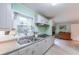Bright kitchen with double sink features generous prep space, ample cabinetry, and views of the greenery outside the window at 2592 Dresden Dr, Atlanta, GA 30341