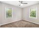 Well-lit bedroom with two large windows, fresh paint, and neutral carpet at 3456 Maryvale Dr, Decatur, GA 30032
