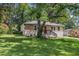Cozy home with a stone and brick exterior, front lawn, and shade trees at 3456 Maryvale Dr, Decatur, GA 30032