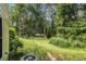 A lush backyard with mature trees, green lawn and a view of the pool at 5357 Highway 81, Loganville, GA 30052