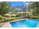 Expansive backyard with a sparkling pool and multiple seating areas, perfect for outdoor enjoyment and entertaining at 5357 Highway 81, Loganville, GA 30052