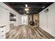 Finished basement with open floor plan, wood burning stove, and wood-look flooring at 5357 Highway 81, Loganville, GA 30052
