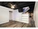 Finished basement area with stone fireplace, tv, and wood look flooring at 5357 Highway 81, Loganville, GA 30052