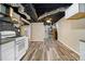 Basement space with kitchenette and open area, featuring wood-look flooring at 5357 Highway 81, Loganville, GA 30052