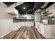 Basement kitchenette with stylish backsplash, shelving, and white appliances at 5357 Highway 81, Loganville, GA 30052