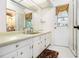 Bathroom with white cabinets and countertops, a view to the shower and tile flooring at 5357 Highway 81, Loganville, GA 30052
