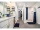 Bathroom with double sinks and vanities, a separate shower with blue and white tile at 5357 Highway 81, Loganville, GA 30052