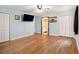 Bedroom with hardwood floors, blue walls, and ceiling fan with two closets and TV mounted on the wall at 5357 Highway 81, Loganville, GA 30052