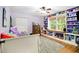 Bedroom with built in shelving around a window and hardwood floors with a cozy rug at 5357 Highway 81, Loganville, GA 30052