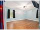 Bright bedroom featuring blue walls, hardwood floors, ceiling fan, window with natural light and cloud design at 5357 Highway 81, Loganville, GA 30052