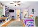 Bedroom with purple walls, built in shelving, hardwood floors and a large gray rug at 5357 Highway 81, Loganville, GA 30052