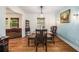 Well-lit dining room features a wooden table, hardwood floors, and stylish wall decor, perfect for Gathering meals at 5357 Highway 81, Loganville, GA 30052