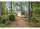 Exterior shot of a shed surrounded by lush foliage at 5357 Highway 81, Loganville, GA 30052