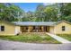 Charming yellow home featuring a covered porch, inviting seating, and a well-maintained walkway and front lawn at 5357 Highway 81, Loganville, GA 30052