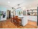 Charming kitchen with hardwood floors, a center island with seating, and modern appliances at 5357 Highway 81, Loganville, GA 30052