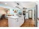 An open kitchen features an island with a sink, stainless steel appliances, and a convenient pantry at 5357 Highway 81, Loganville, GA 30052