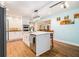 A lovely kitchen showcases an island with a sink, modern light fixtures, and stainless steel appliances at 5357 Highway 81, Loganville, GA 30052