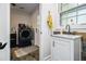 A bright laundry room features a utility sink and slate flooring at 5357 Highway 81, Loganville, GA 30052