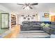 Spacious living room with hardwood floors, plush seating, and built-in shelving, perfect for relaxation and entertainment at 5357 Highway 81, Loganville, GA 30052