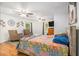 Spacious bedroom with hardwood floors, ceiling fans, two arm chairs and a large bed at 5357 Highway 81, Loganville, GA 30052