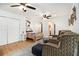 Bright main bedroom boasts hardwood floors, ceiling fan and sitting area at 5357 Highway 81, Loganville, GA 30052