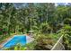 A beautifully maintained swimming pool with a hot tub and well-manicured landscaping at 5357 Highway 81, Loganville, GA 30052