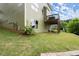 View of the side of the home with a wooden deck and green lawn at 216 Toonigh Way, Canton, GA 30115