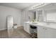Bathroom featuring dual sinks, tile floor, and a large mirror at 216 Toonigh Way, Canton, GA 30115