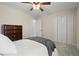 Bedroom with carpeted floor, ceiling fan and double door closet at 216 Toonigh Way, Canton, GA 30115