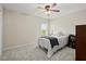 Cozy bedroom featuring a ceiling fan, window with blinds and plush carpet at 216 Toonigh Way, Canton, GA 30115