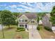 Aerial view of a two-story home featuring a well-manicured lawn and mature trees at 216 Toonigh Way, Canton, GA 30115