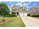 Charming home with a two-car garage and meticulously maintained front yard landscaping at 216 Toonigh Way, Canton, GA 30115