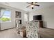 Bright living room featuring a fireplace, wood flooring, and ceiling fan at 216 Toonigh Way, Canton, GA 30115