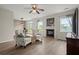 Bright living room featuring a fireplace, wood flooring, and ceiling fan at 216 Toonigh Way, Canton, GA 30115