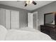Spacious main bedroom with white walls, ceiling fan and double-door closet at 216 Toonigh Way, Canton, GA 30115