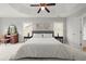Spacious main bedroom features a tray ceiling, bedside tables, and two windows at 216 Toonigh Way, Canton, GA 30115