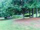 Beautiful backyard featuring mature trees, green grass, and well-maintained landscaping at 2805 Ne Expressway Unit A24, Atlanta, GA 30345