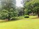Picturesque backyard with mature trees, lush lawn, and view of the property at 2805 Ne Expressway Unit A24, Atlanta, GA 30345