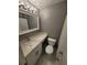 Modern bathroom with a sink, toilet, marble countertops, and an updated mirror at 2805 Ne Expressway Unit A24, Atlanta, GA 30345