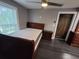 Bedroom with dark wood floors, bed, ceiling fan, dresser, and natural light at 2805 Ne Expressway Unit A24, Atlanta, GA 30345