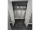 Open closet with dark wood floors, gray walls, white shelving, and white doors at 2805 Ne Expressway Unit A24, Atlanta, GA 30345